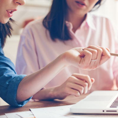 Two women working at a computer