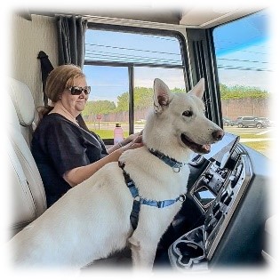 Deb and her dog driving an RV