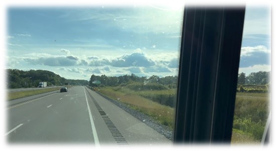 Looking out the front window of an RV at the open road ahead