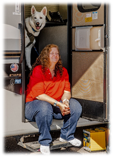 Deb sitting in the doorway of an RV